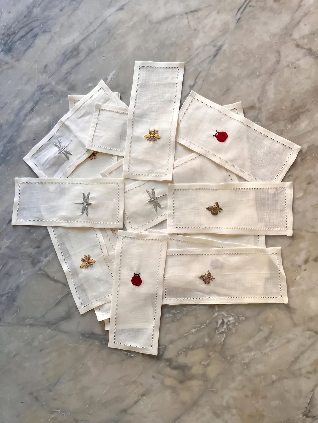 Linen napkins embroidered with a ladybird, dragonfly, bee and butterfly