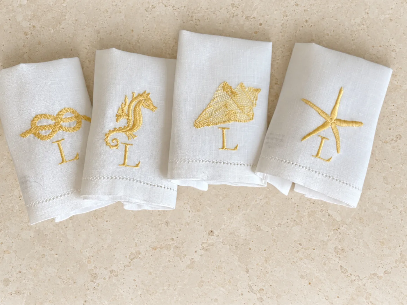 The marine napkins embroidered in mimosa yellow